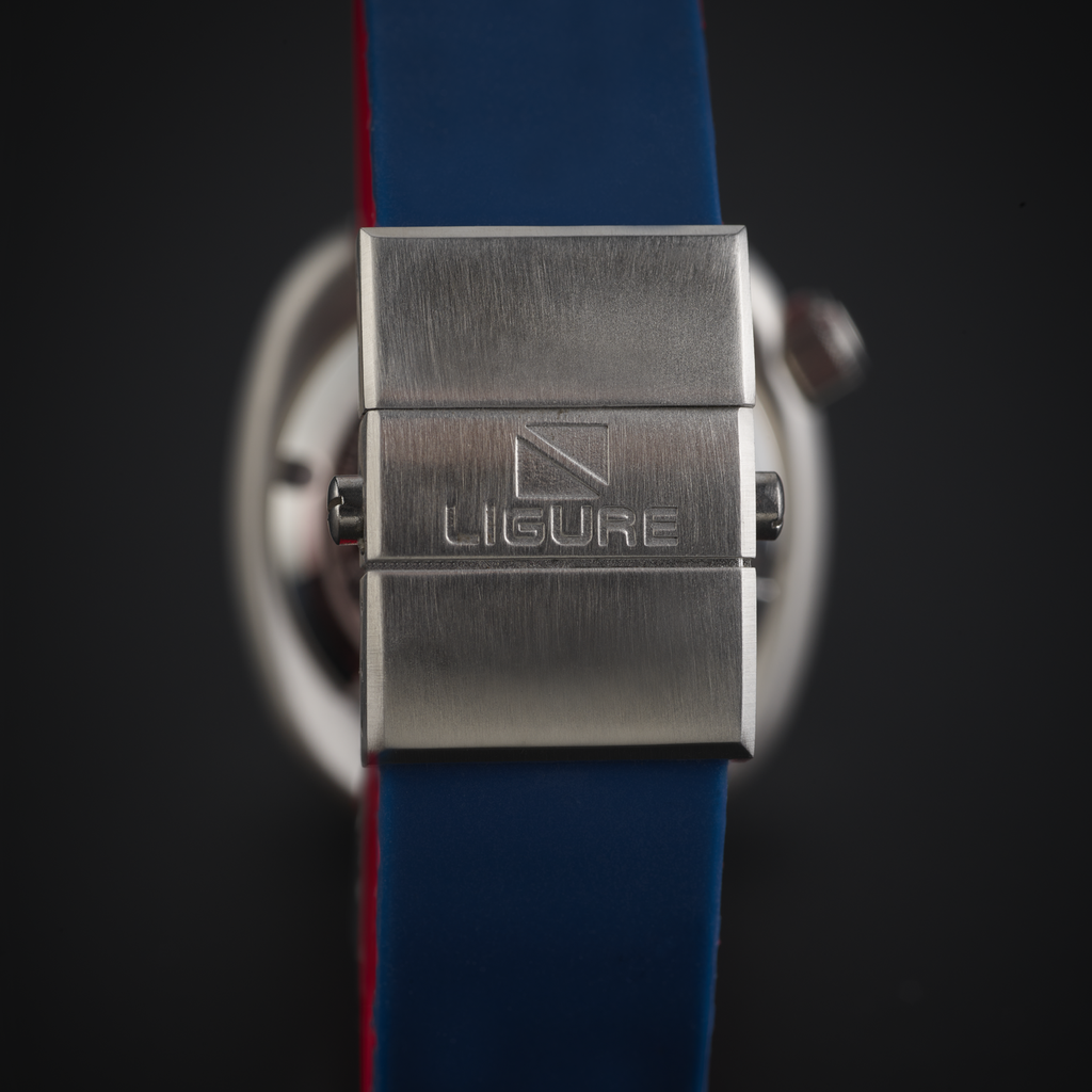 Close-up of a Ligure Founders Edition GMT LWT21007 watch with a blue strap and metal clasp on a dark background